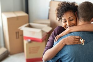 Young,African,Woman,Holding,Home,Keys,While,Hugging,Boyfriend,In